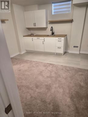 Clarington (Newcastle) apartment for rent - A kitchen with white cabinets and a sink.