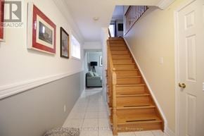Markham (Old Markham Village) townhouse for rent - A staircase with a light brown wooden banister and white walls.