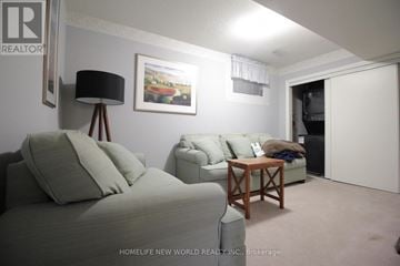 Markham (Old Markham Village) townhouse for rent - A living room with a grey couch and a wooden coffee table.