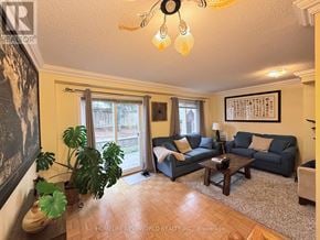 Markham (Old Markham Village) townhouse for rent - A living room with a couch, chair, and potted plant.