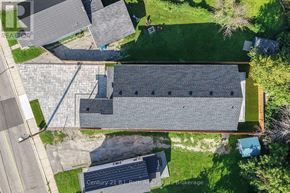 Orillia triplex for rent - An aerial view of a building with a grey roof and a blue container in front of it.