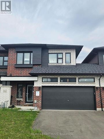 Severn (West Shore) townhouse for rent - A modern house with a black garage door is for sale.