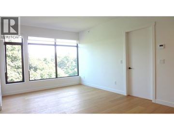 Vancouver apartment for rent - A large empty room with a window and a door.