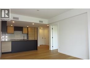 Vancouver apartment for rent - A realtor sign is on the wall in a large empty room.