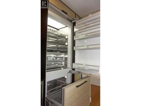 Vancouver apartment for rent - A kitchen with a refrigerator and a drawer.
