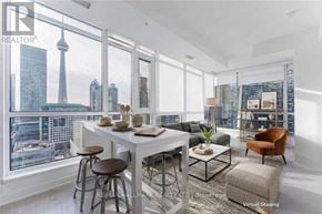 Toronto (Waterfront Communities) condo for rent - A modern dining room with a view of the city skyline.