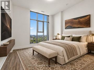 Toronto (Mount Pleasant West) condo for rent - A bedroom with a large bed and a view of the city.
