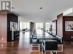 Toronto (Moss Park) condo for rent - A spacious room with a long table and chairs.
