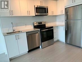 Toronto (Humber Heights) condo for rent - A kitchen with white cabinets and stainless steel appliances.