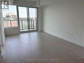 Toronto (Humber Heights) condo for rent - A large empty room with a view of a building outside the window.