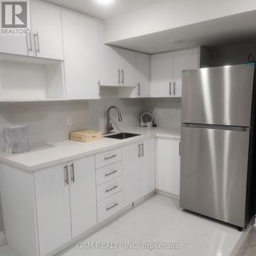 Mississauga (East Credit) apartment for rent - A kitchen with white cabinets and a stainless steel refrigerator.