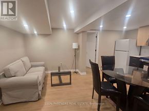 Toronto (Bayview Village) apartment for rent - A real estate office with a white couch and a black chair.