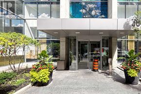 Toronto (Bay Street Corridor) condo for rent - The front of a building with a glass wall and a sign that says REALTOR.