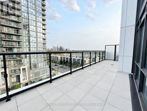 Mississauga (Hurontario) condo for rent - A balcony with a glass railing overlooks a cityscape.
