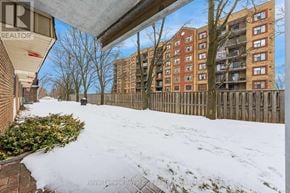Guelph (Junction/Onward Willow) condo for rent - A snow-covered ground with a building in the background.
