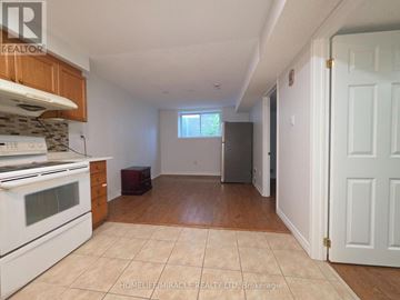 Brampton (Fletcher's Creek South) apartment for rent - A kitchen with white appliances and wooden cabinets.
