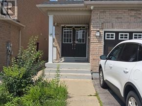 Brampton (Fletcher's Creek South) apartment for rent - A white car is parked in front of a house with a black door.