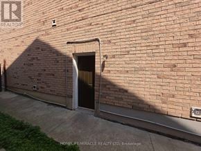 Brampton (Fletcher's Creek South) apartment for rent - A brick wall with a doorway and a sign that says "REALTOR".