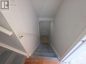 Brampton (Fletcher's Creek South) apartment for rent - A stairway with a white wall and a door at the top.
