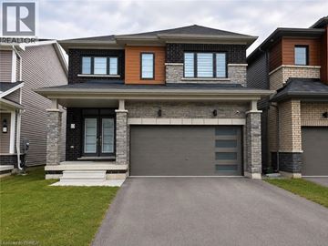 Brantford apartment for rent - A modern house with a grey garage door and a black front door.
