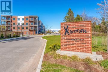 Clearview (Creemore) condo for rent - A brick sign with the word Xreemore on it is in front of a building.