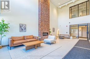 Clearview (Creemore) condo for rent - A living room with a couch, a fireplace, and a plant.