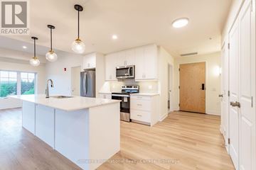 Clearview (Creemore) condo for rent - A modern kitchen with white cabinets and a wooden floor.
