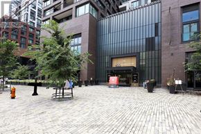 Toronto (Waterfront Communities) condo for rent - A brick building with a large glass window and a sign that says 4655.