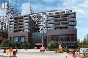 Toronto (Waterfront Communities) condo for rent - A building with a sign that says RE/MAX Realty Specialists Inc. Brokerage.