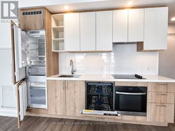 Vaughan (Vaughan Corporate Centre) condo for rent - A kitchen with white cabinets and appliances, including a refrigerator, oven, and microwave.