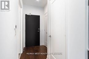 Toronto (Edenbridge-Humber Valley) condo for rent - A hallway with a black door and white walls.