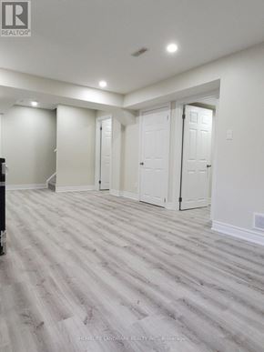 Milton (Ha Harrison) apartment for rent - A room with white walls and a wooden floor.