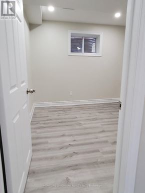 Milton (Ha Harrison) apartment for rent - A hallway with wooden flooring and white walls.