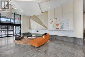 Toronto (Dovercourt-Wallace Emerson-Junction) condo for rent - A modern living room with a large orange sofa and a coffee table.
