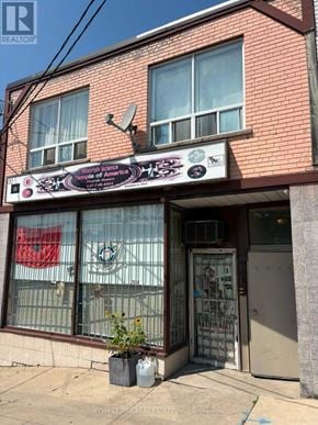 Toronto (Beechborough-Greenbrook) apartment for rent - A red brick building with a sign that says "State of America".