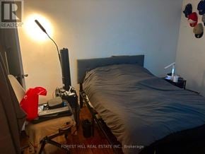 Toronto (Beechborough-Greenbrook) apartment for rent - A bedroom with a bed, desk, and lamp.