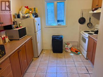 Toronto (Beechborough-Greenbrook) apartment for rent - A kitchen with a refrigerator, microwave, and oven.