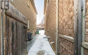 Brampton (Fletcher's Meadow) apartment for rent - A narrow alley with brick walls and a wooden door on the left.