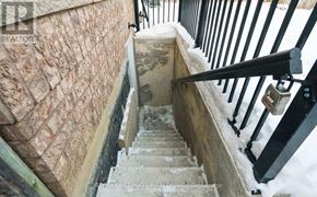 Brampton (Fletcher's Meadow) apartment for rent - A staircase with a stone wall and a black railing.