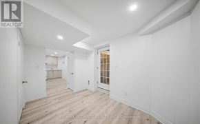 Brampton (Fletcher's Meadow) apartment for rent - A white room with wood flooring and a doorway leading to another room.