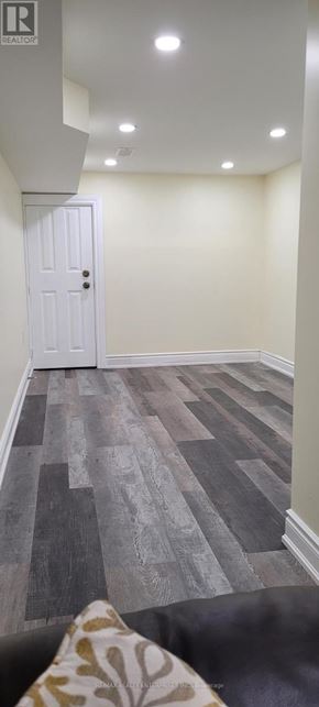 Toronto (Weston-Pellam Park) apartment for rent - A room with a white door and a wooden floor.