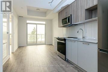 Burlington (Lasalle) condo for rent - A modern kitchen with white cabinets and a microwave above the oven.