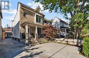 Toronto (Weston-Pellam Park) apartment for rent - A house with a stone facade and a large front yard.