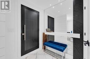 Toronto (Weston-Pellam Park) apartment for rent - A modern bathroom with a black door and a blue bench.