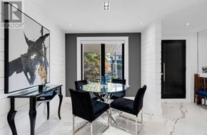 Toronto (Weston-Pellam Park) apartment for rent - A modern dining room with a glass table and black chairs.
