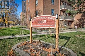 Mississauga (Applewood) condo for rent - A sign for Queen Frederick Drive stands in front of a brick building.