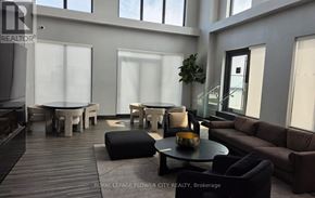 Hamilton (Corktown) condo for rent - A modern living room with a wooden floor and furniture.