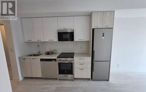 Hamilton (Corktown) condo for rent - A kitchen with white cabinets and stainless steel appliances.