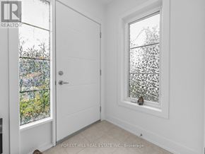 Stratford townhouse for rent - A white door with a glass window on the left and a white wall on the right.