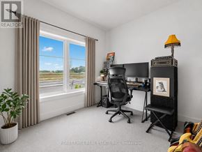 Stratford townhouse for rent - A room with a desk, chair, and a window with a view of the outside.